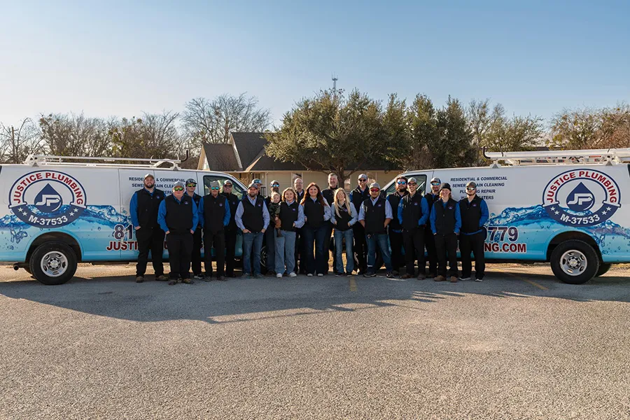 Full Justice Plumbing crew in Granbury, TX standing with branded vans, emphasizing expert plumbing repair, maintenance, and local service.