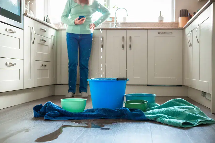 leak with water dripping and buckets